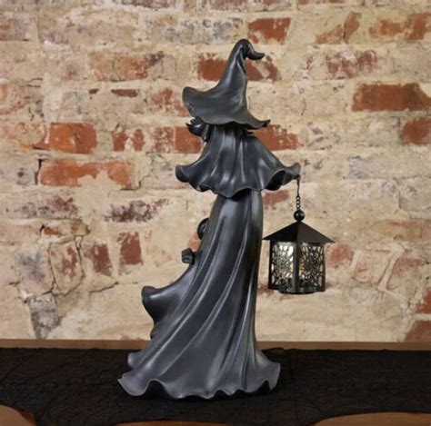 Witch sculpture with lantern for halloween at cracker barrel